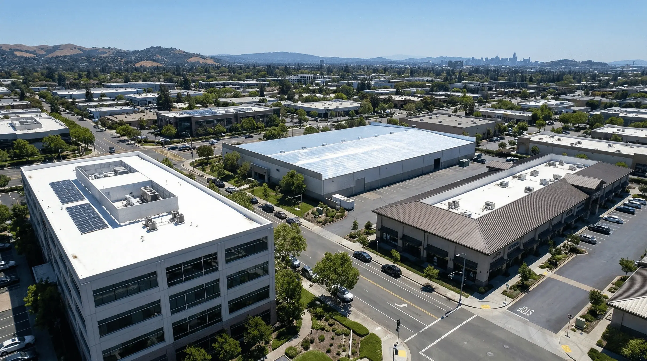 Bay Area commercial buildings with modern roofing systems including TPO, metal, and tile.